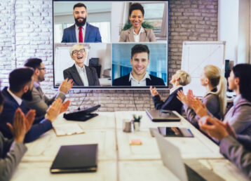 Business people looking at a screen during a video conference in the conference room